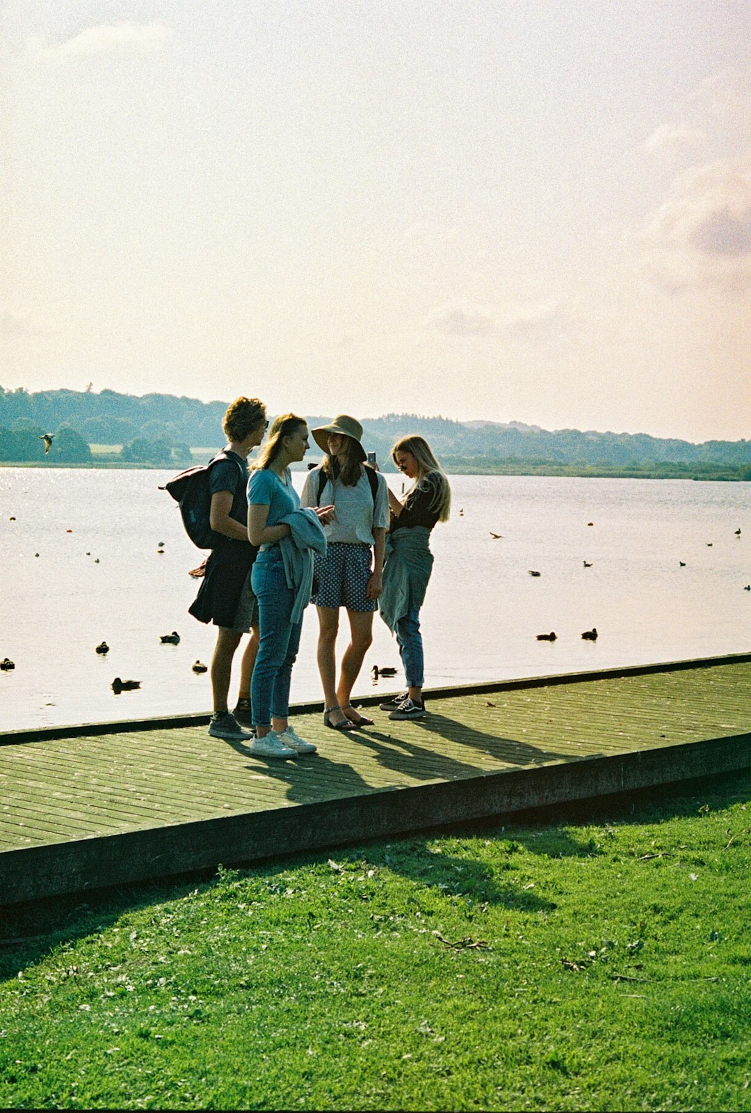 Group of diverse Danish teenagers laughing together outdoors